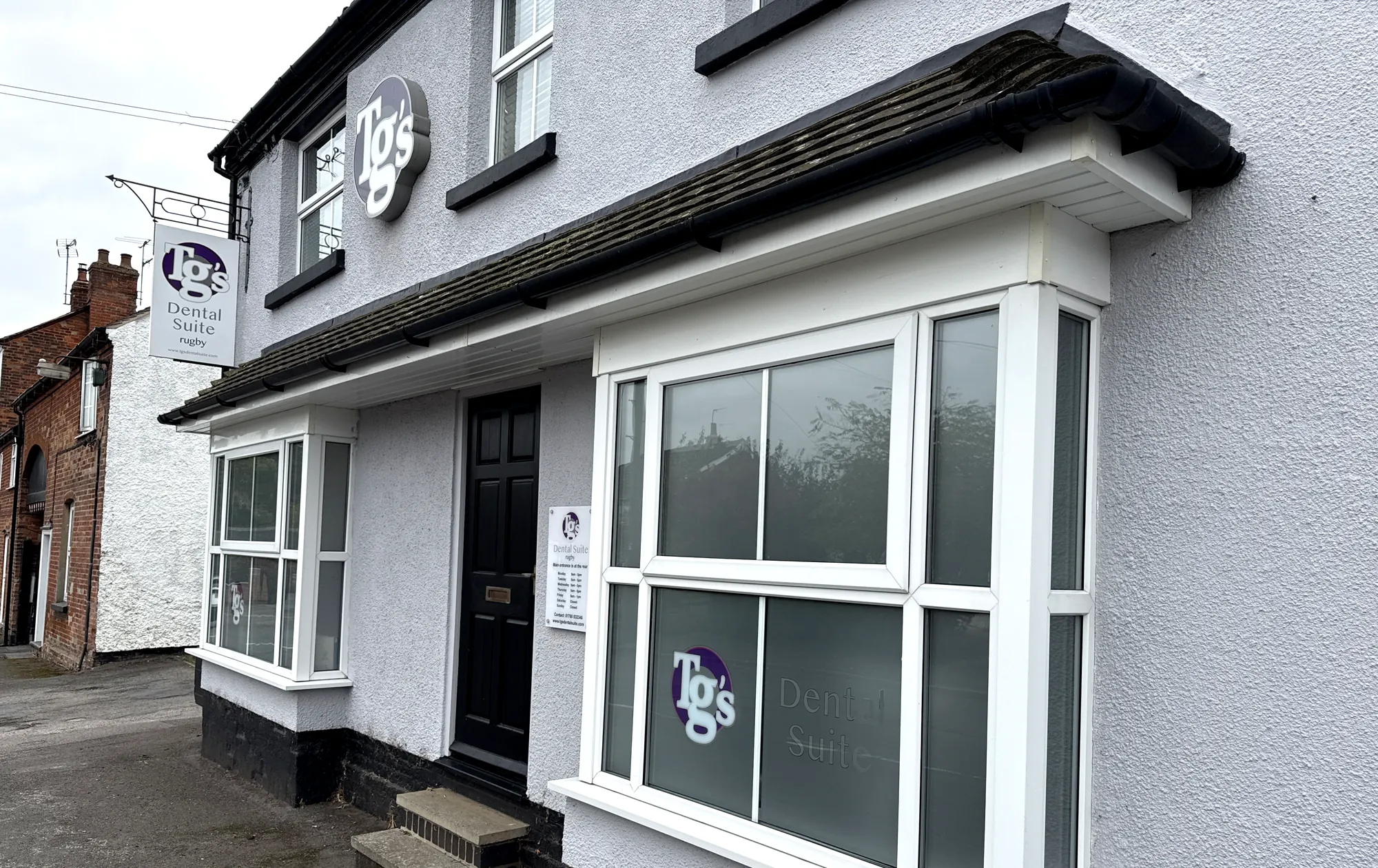 The TG's Dental Suite Rugby frontage, with the wall roundel, hanging sign and bay windows