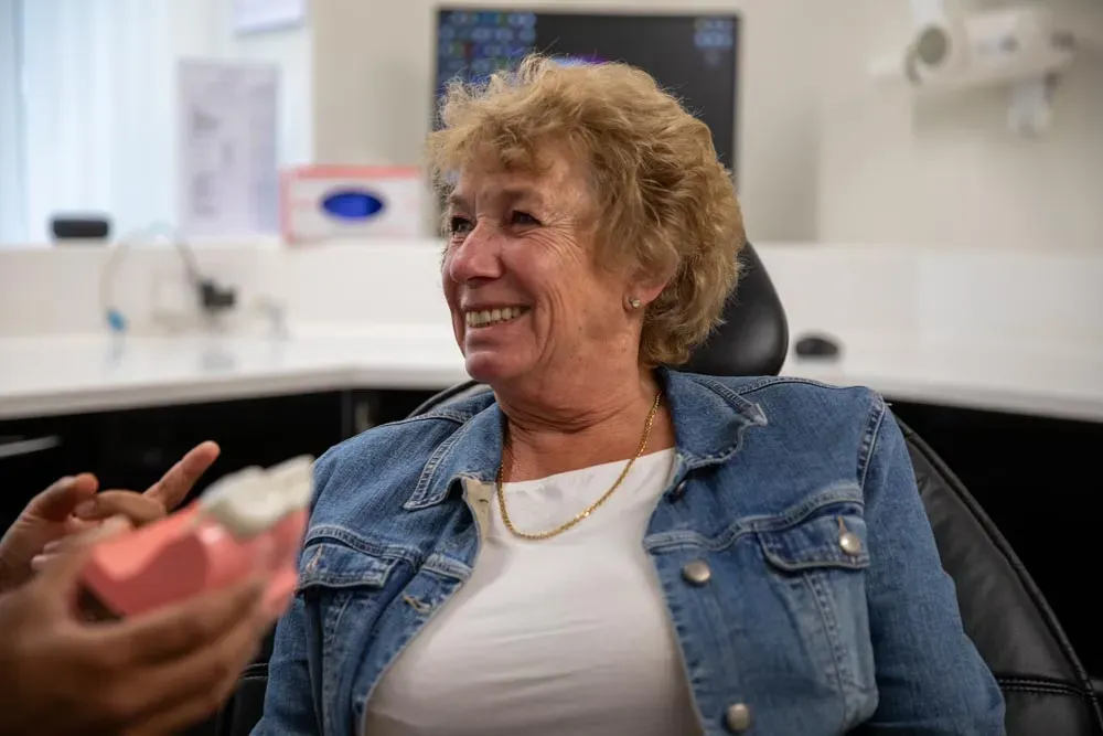 Close-up of a smiling patient in the treatment chair during a consultation
